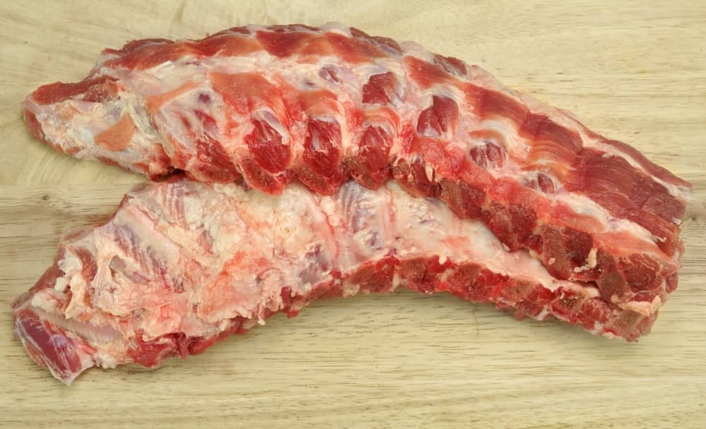 Baby back ribs are from the top portion of the rib cage. They have more meat and take less time to cook than spareribs.