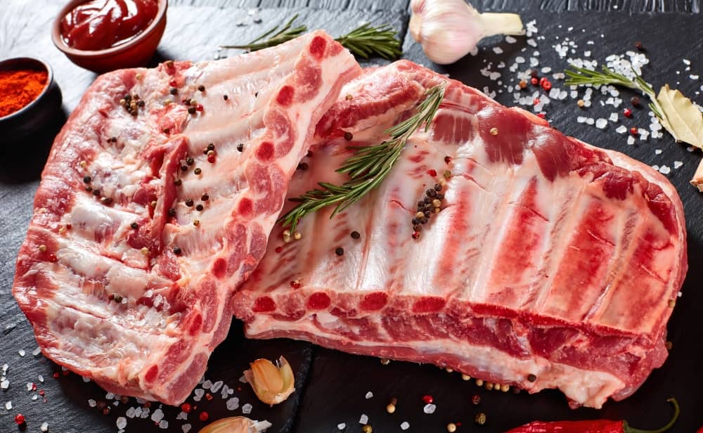 Spareribs are from the bottom portion of the ribs. With longer bones, they have less meat than baby backs.