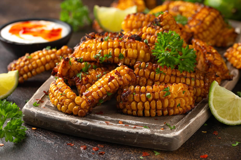 BBQ corn ribs on a plate with garnishing and dip.