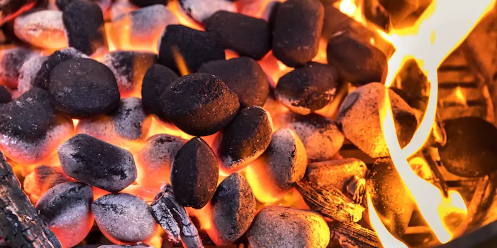 Charcoal briquettes on a grill
