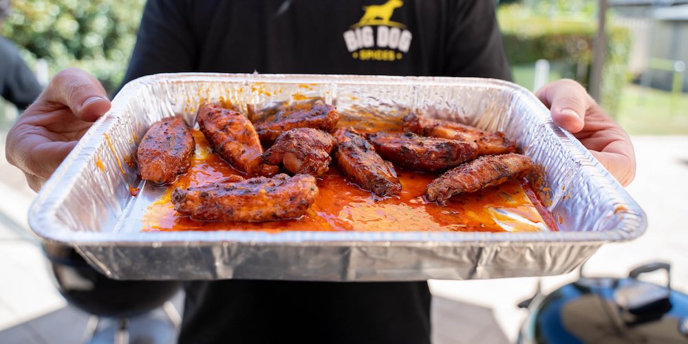 Brad holding chicken wings with the best spices for chicken on them