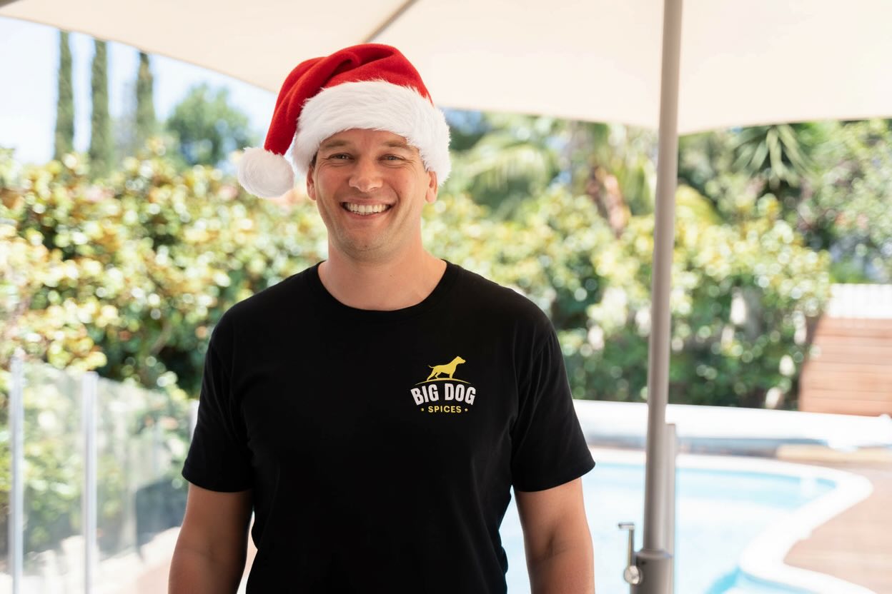 Brad smiling wearing a Big Dog Spices apron and a Christmas hat